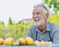 Man smiles outdoors